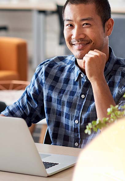 Man in front of laptop Avelo careers